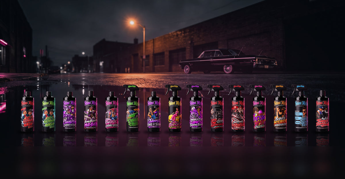 All fifteen Shine Mafia bottles in a row on a wet street, a black lowrider under a streetlight behind them
