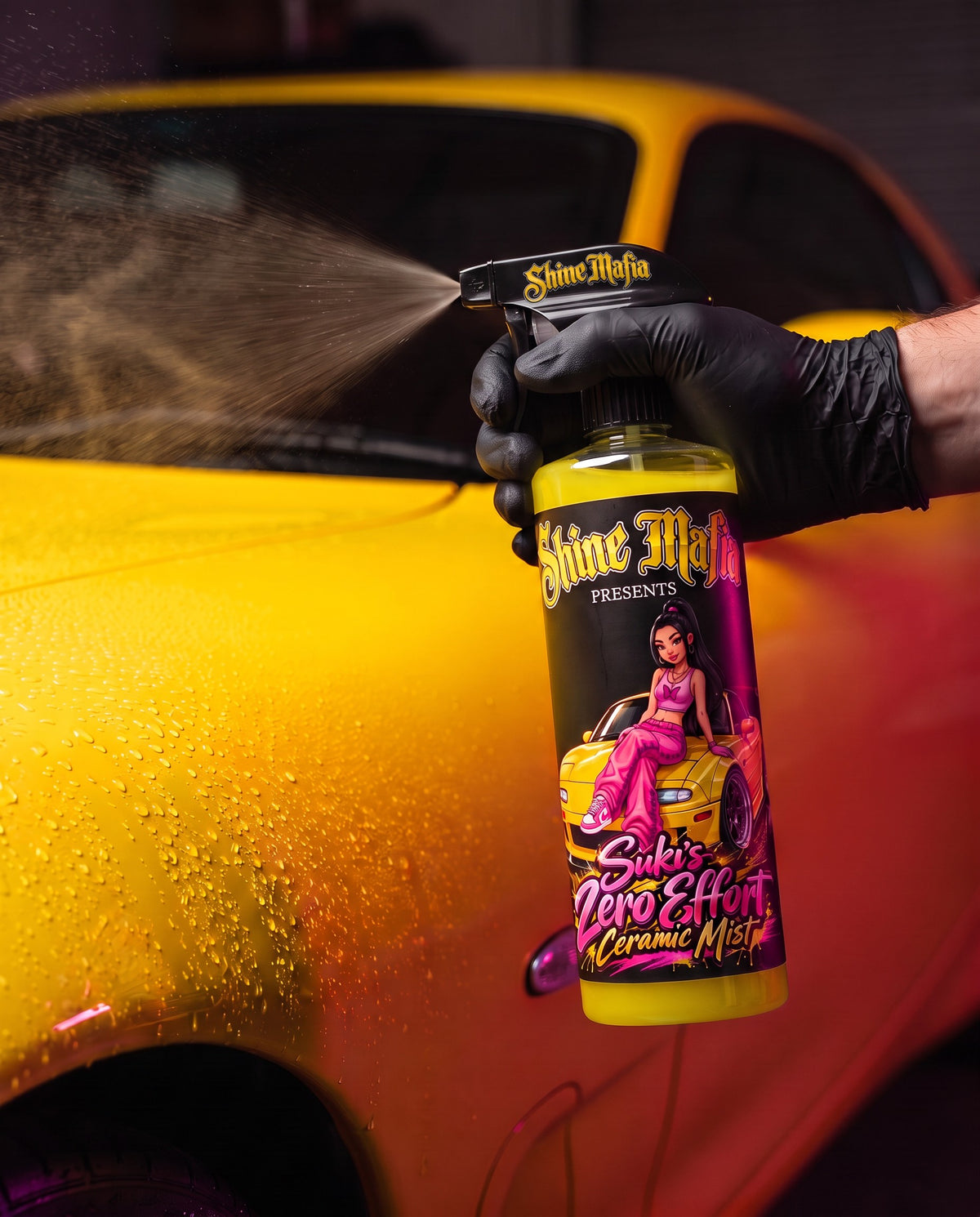 Spraying Suki's Zero Effort Ceramic Mist onto yellow car paint