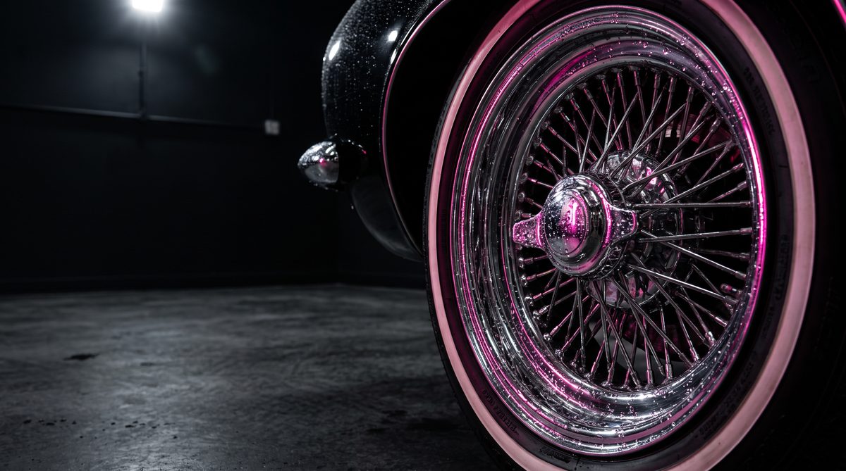 A chrome wire wheel and whitewall tire on a lowrider