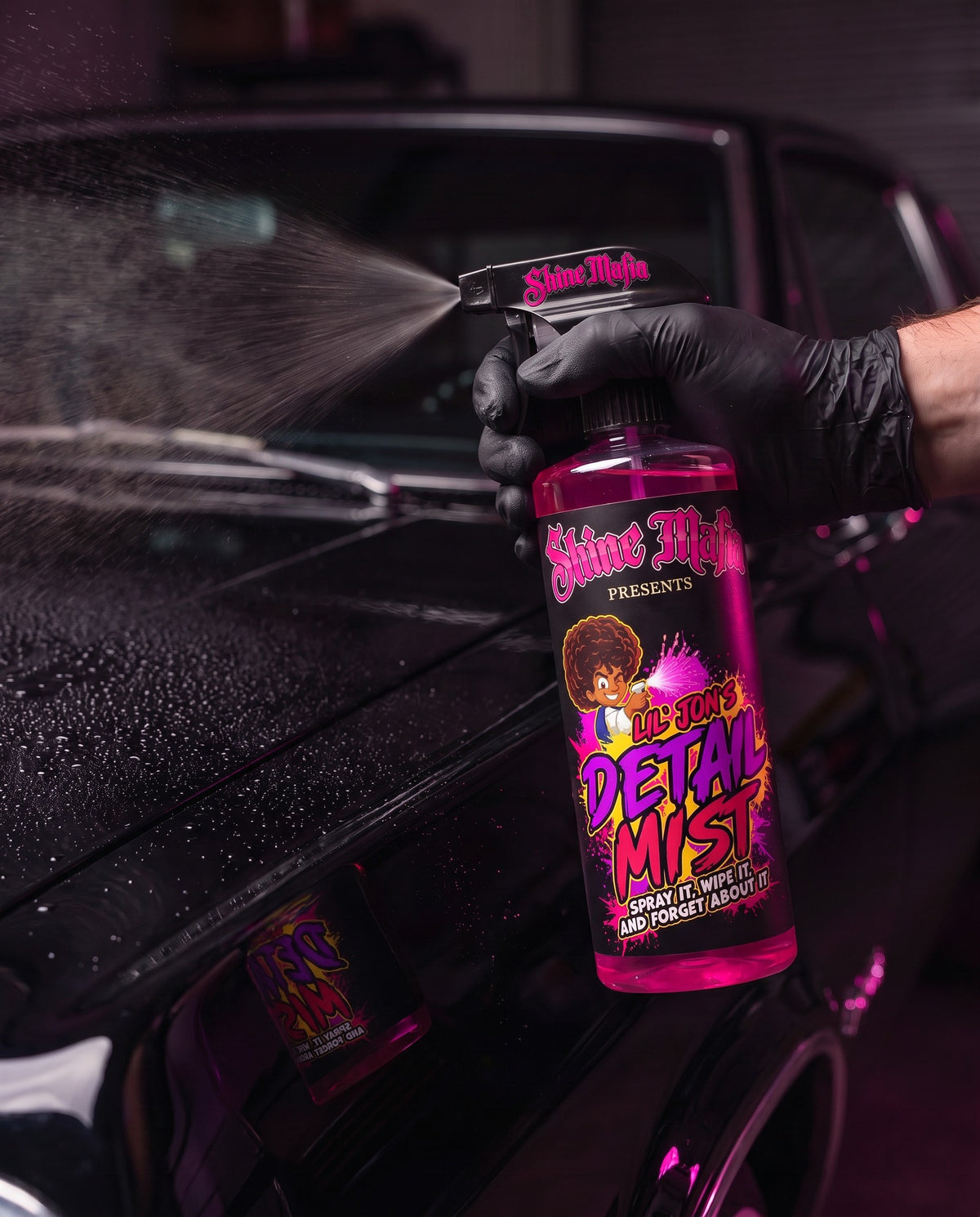 Spraying Lil' Jon's Detail Mist on black car paint