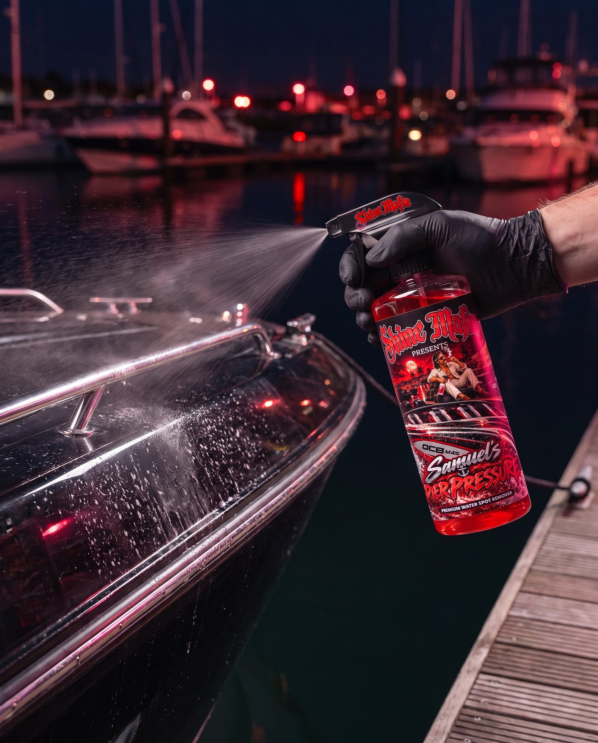 Spraying Samuel's Pier Pressure on the black hull of a boat at the marina