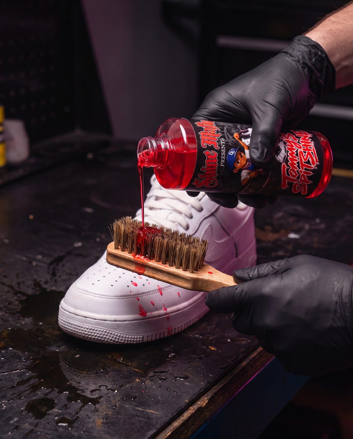Pouring Tommy's Spit Shine onto a sneaker brush